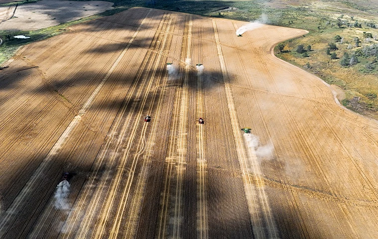 Aerial view of tractors working a cultivated paddock